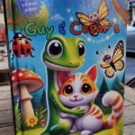 Angled hardcover photo of Guy & Cesar’s Big Adventure in Safety Land book on a wooden surface.